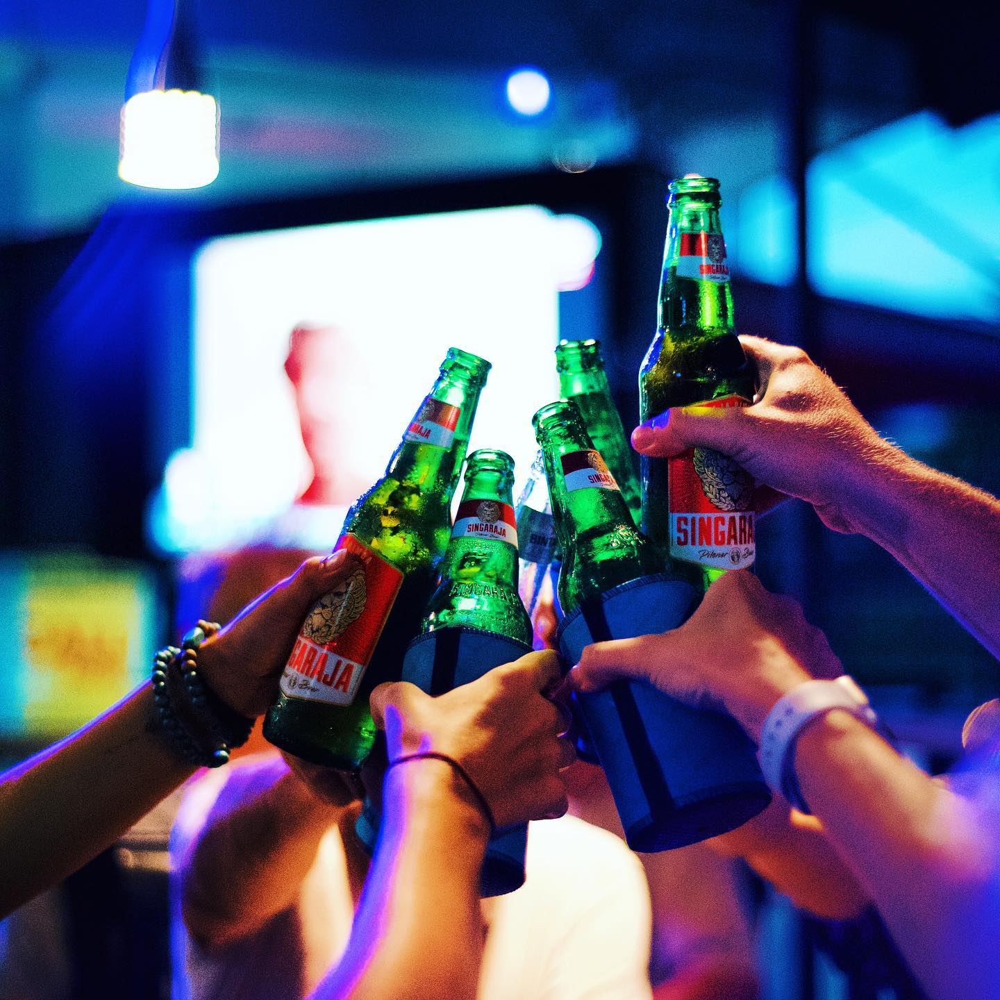 Cold beers raised together inside The Bucket sports bar